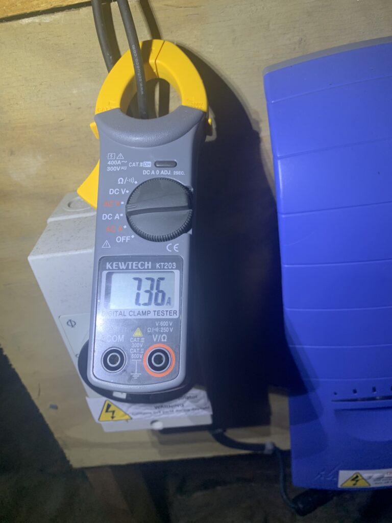 Clamp meter testing a circuit during an EICR, the inspection work we do at Melchbourne Park