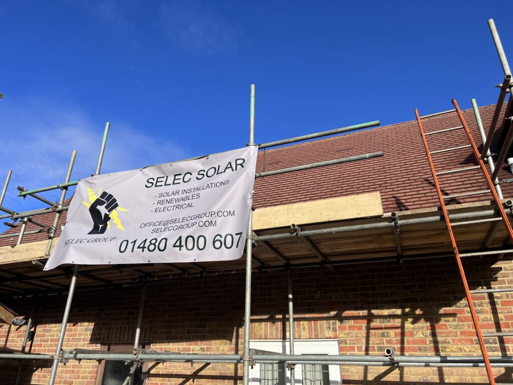 Scaffolding and a Selec Solar banner on a house in Brampton, Cambridgeshire, ready for a solar install