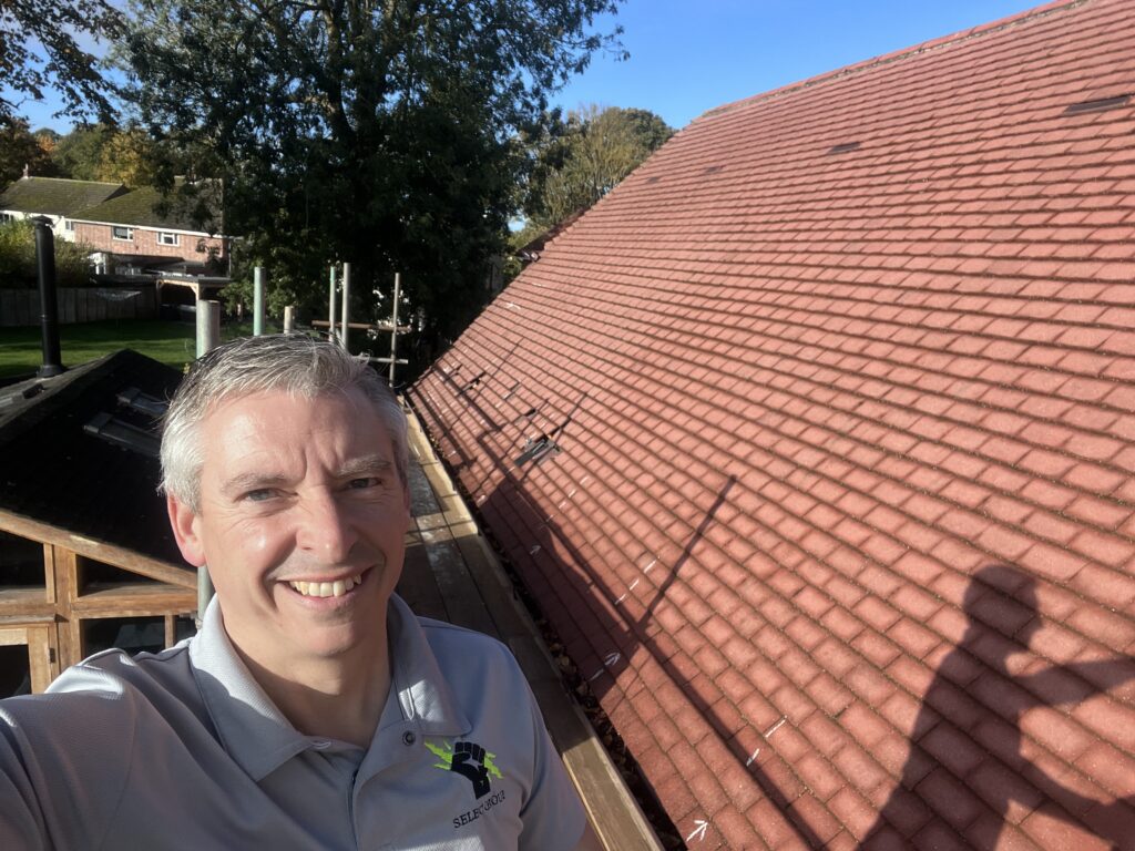 Jason Pope on the scaffold beside the tiled roof before the Brampton solar panels went on