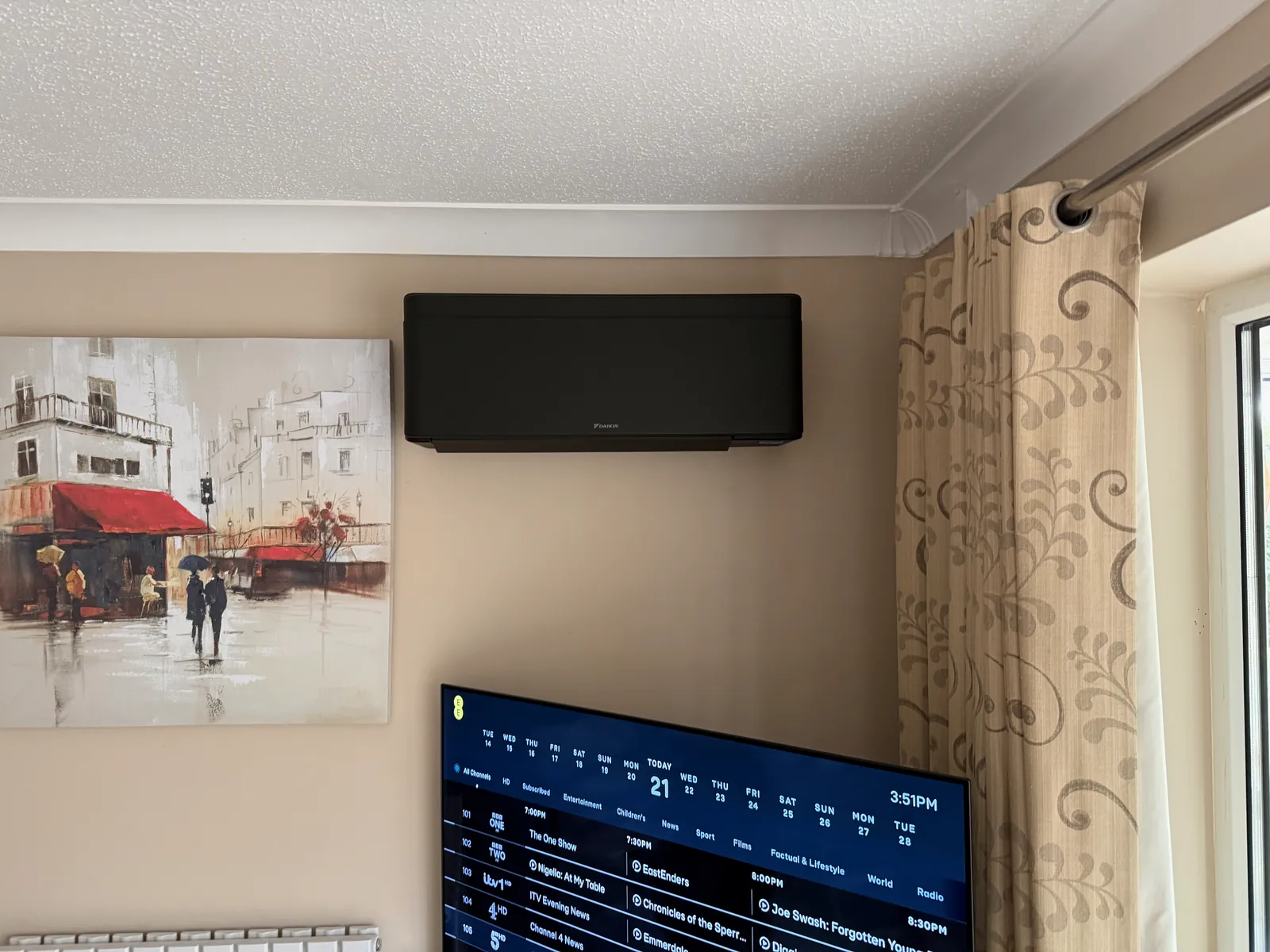 Black Daikin air conditioning unit in a living room in Ellington Thorpe, fitted by Selec Group