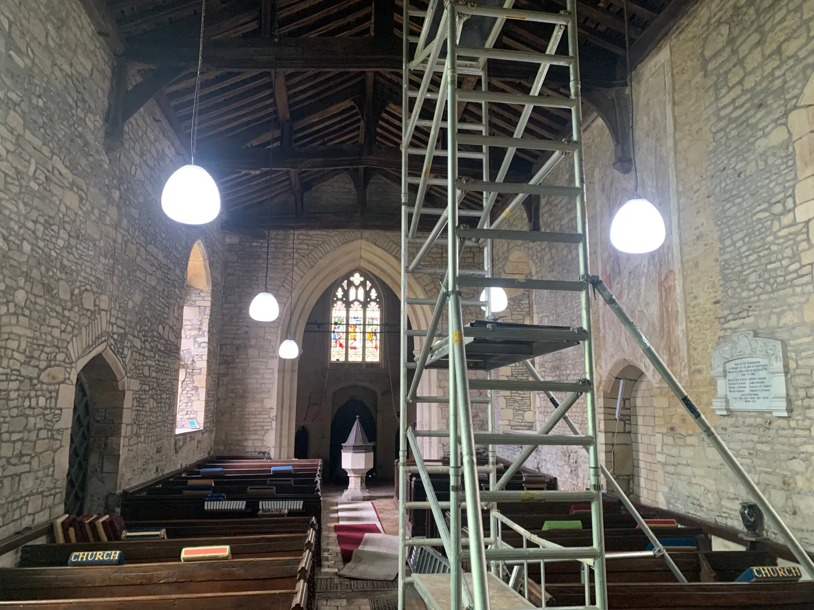 New lighting being installed in a church in Thurleigh by Selec Group