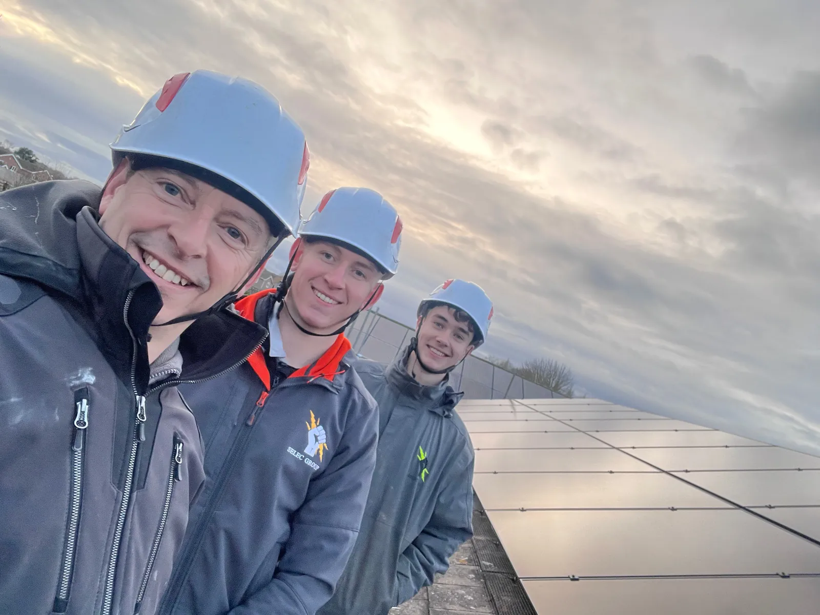 Jason Pope and the Selec Group team in safety helmets on a solar install in Perry