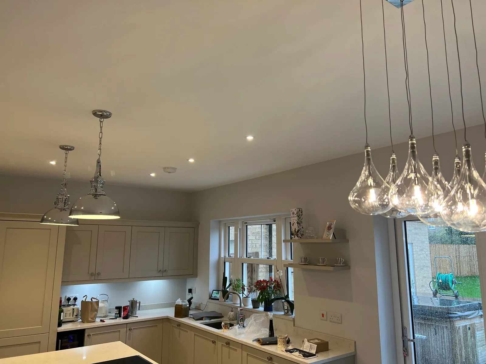 Kitchen with pendant lights over the worktop and downlights, wired by Selec Group