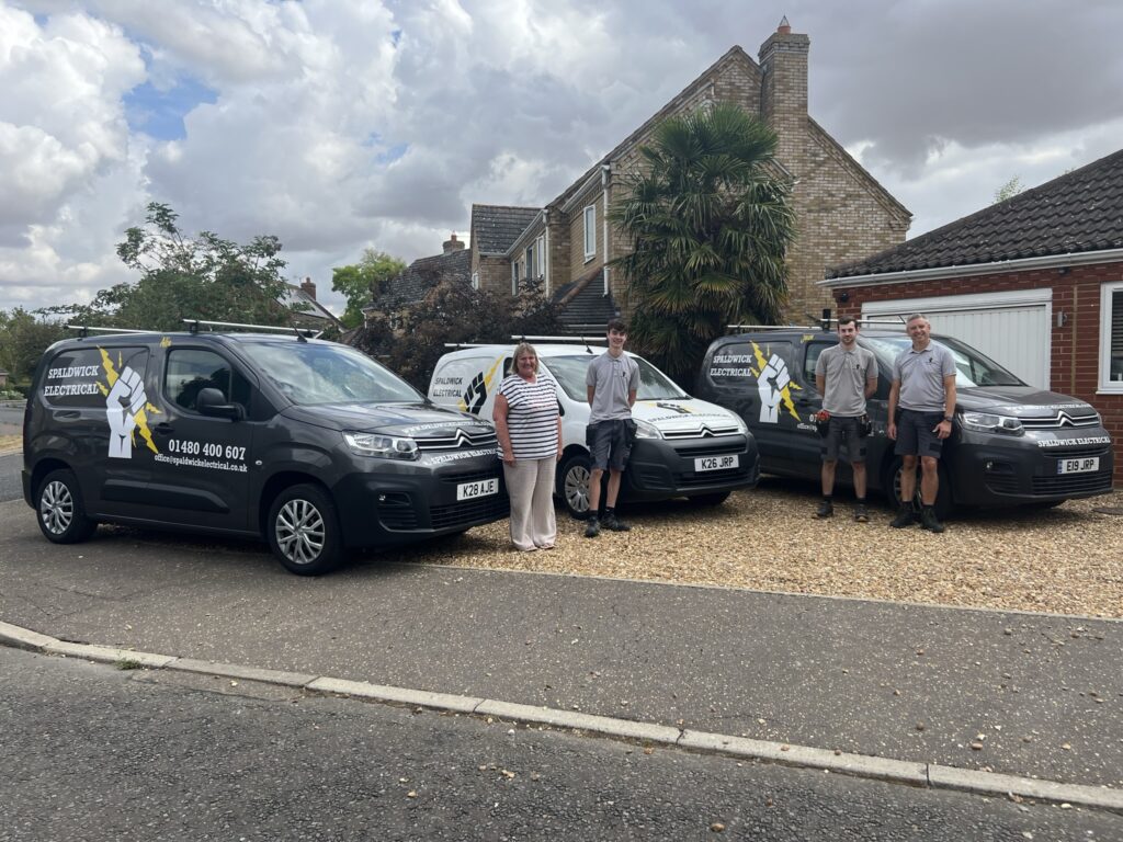 The Selec Group team with three of our vans, the company that grew out of Spaldwick Electrical