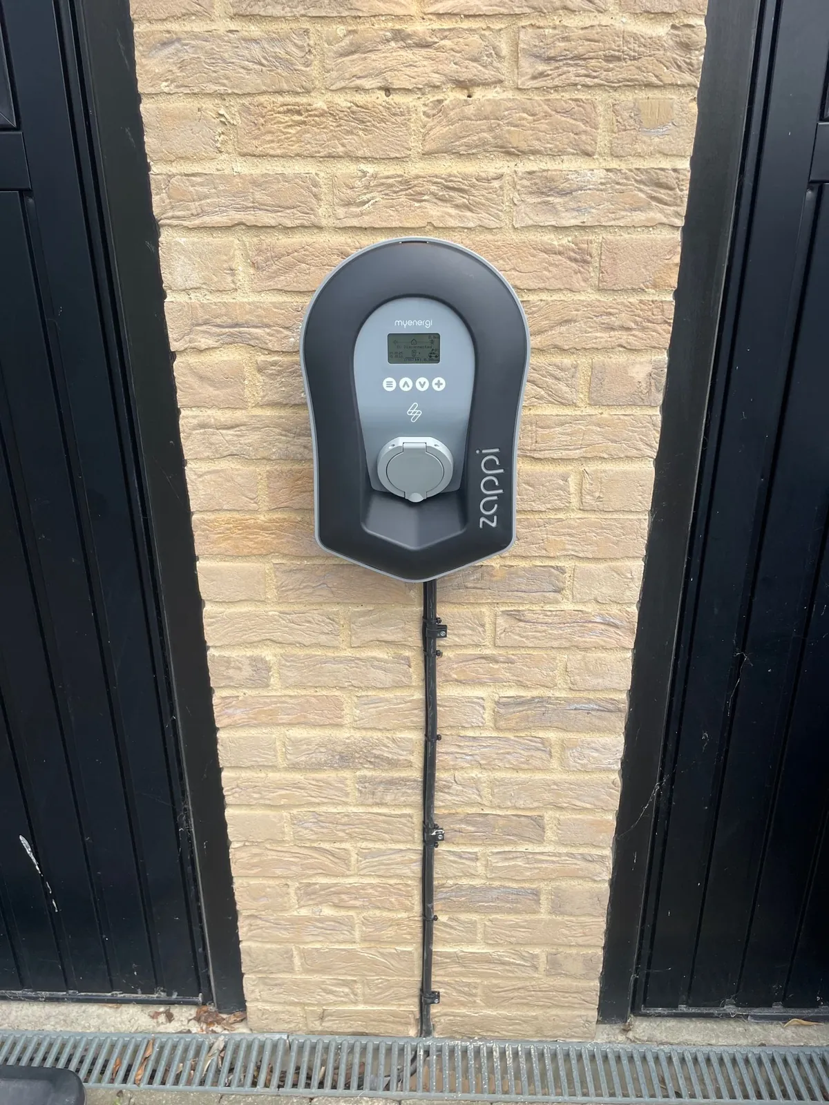 Zappi EV charger fitted between timber cladding by Selec Group